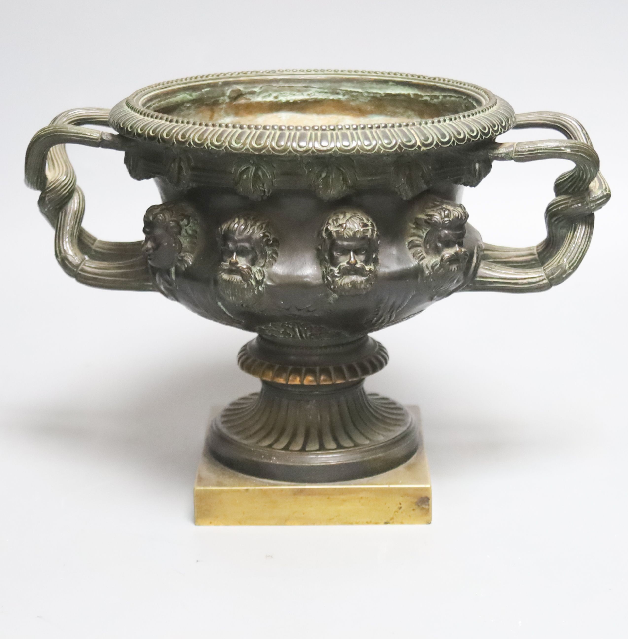 After the antique a bronze Warwick vase of typical form on square plinth foot. 19cm